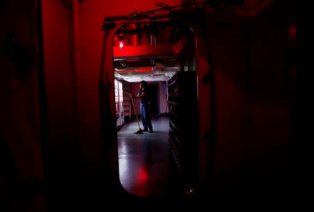 A sailor takes a break while he mops a corridor in Japanese helicopter carrier Kaga in the Indian Ocean, Indonesia September 23, 2018. Picture taken on September 23, 2018. REUTERS/Kim Kyung-Hoon