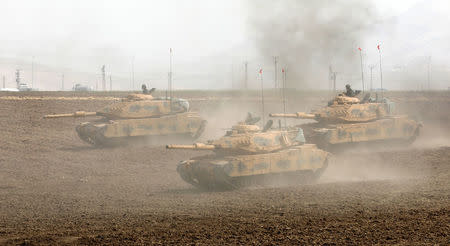 Turkish tanks maneuver during a military exercise near the Turkish-Iraqi border in Silopi, Turkey. REUTERS/Umit Bektas