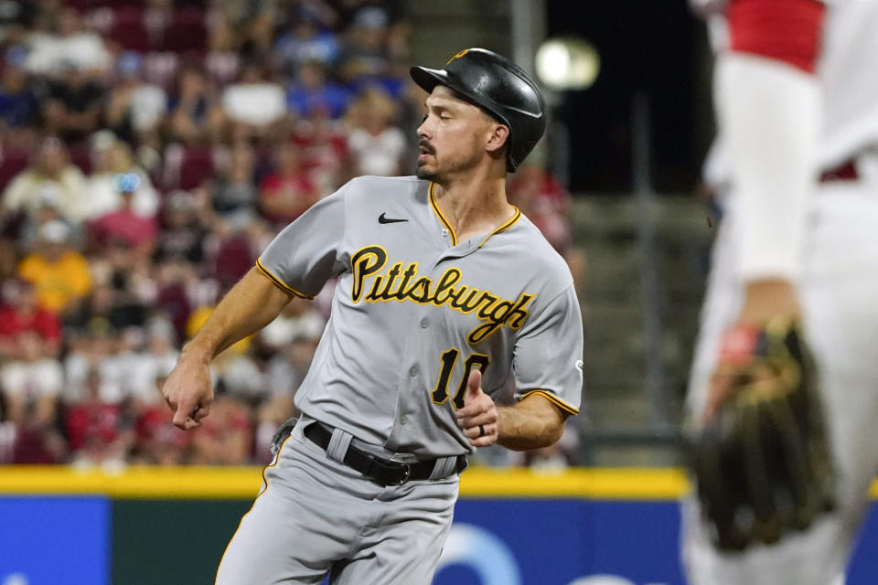 Pittsburgh Pirates' Bryan Reynolds (10) goes to third base on an RBI single hit by Ke'Bryan Hayes in the fifth inning of a baseball game against the Cincinnati Reds in Cincinnati on Thursday, Aug. 5, 2021. (AP Photo/Jeff Dean)