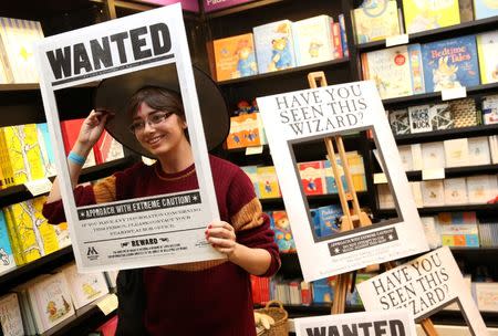 A fan poses for a photograph at an event to mark the release of the book of the play of Harry Potter and the Cursed Child parts One and Two at a bookstore in London, Britain July 30, 2016. REUTERS/Neil Hall