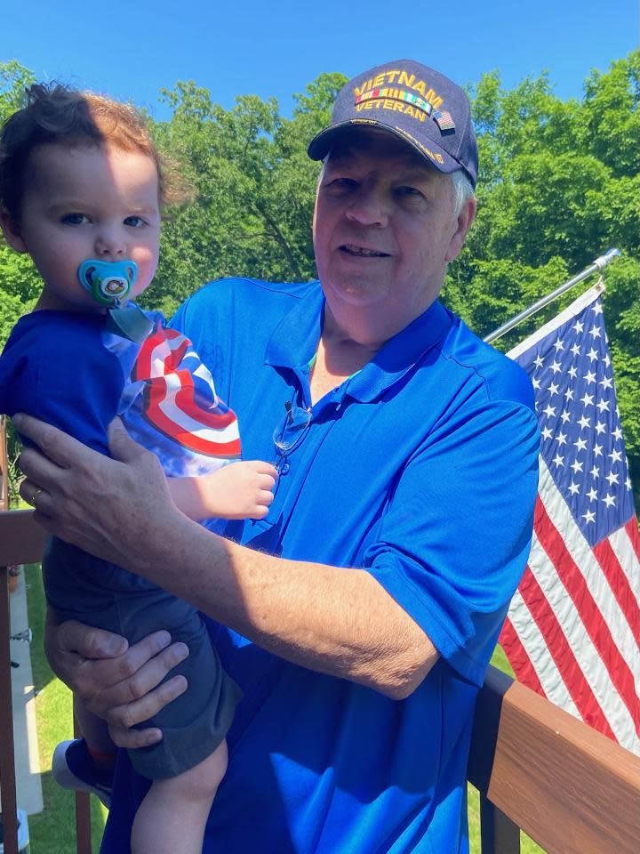 Jack Felton of Green Township holds his grandson, Theo.