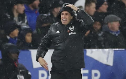  Arsenal manager Unai Emery with his hood up and the rain pelting down on him - Credit: Action Images via Reuters/Carl Recine&nbsp;