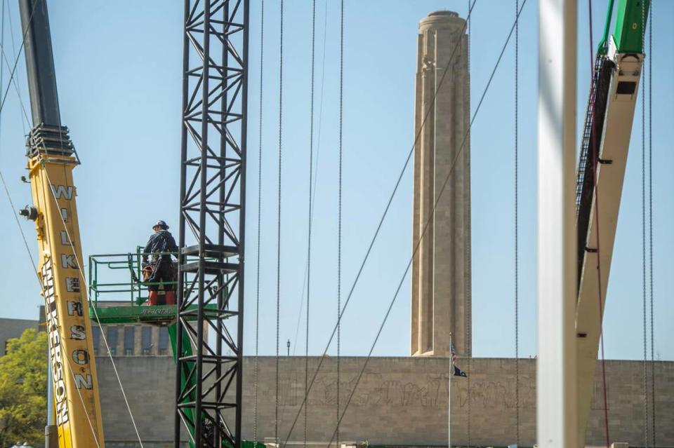 A construction worker works from a lift while assembling the NFL Draft theater at Union Station.