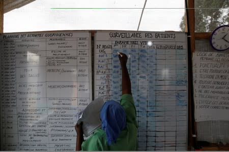 A health worker updates data on a board at an Ebola transit centre in town of Katwa, near Butembo