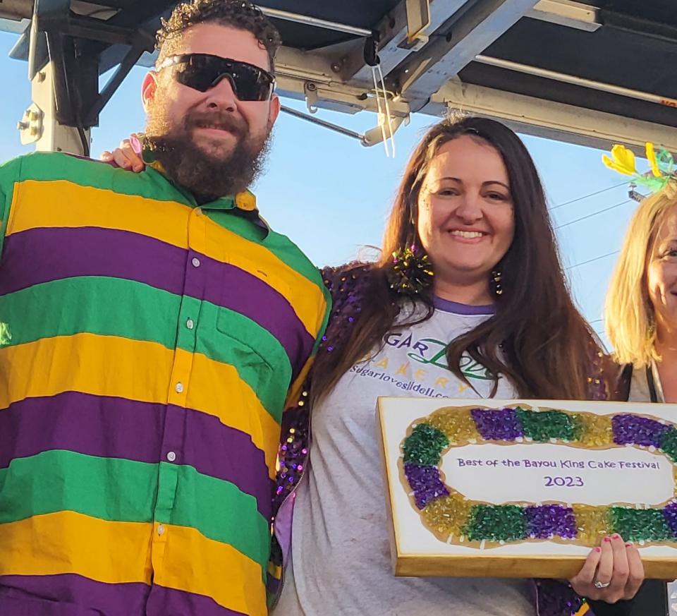 Sugar Love Bakery owner Sierra Zeringue and her husband, Jeff, receive an award after the Slidell bakery won top prize in Thibodaux's inaugural Bayou King Cake Festival on Saturday, Feb. 4, 2023.