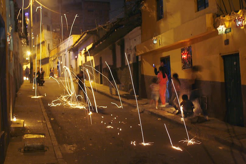 A child carries a sparkler during celebrations to mark Dia de las Velitas, or Candle Day, at the neighborhood of Belen in Bogota.