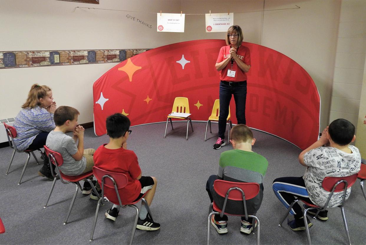 Cindy Massie leads second-graders of Conesville Elementary School in prayer at Lifewise program at Conesville United Methodist Church. More than 90 students from Conesville Elementary School are participating in the release time program.