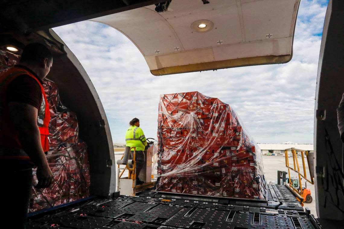 Avianca Cargo employees unload boxes with flowers from a cargo plane arriving at Miami International Airport on Monday, Feb. 6, 2023.