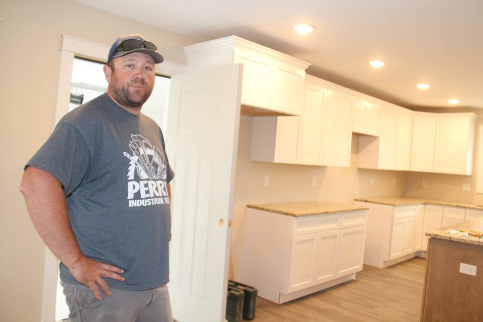 Chad Morman, Perry High School industrial tech instructor, stands inside of the spec home being built by his building trades students on Otley Avenue in 2021.