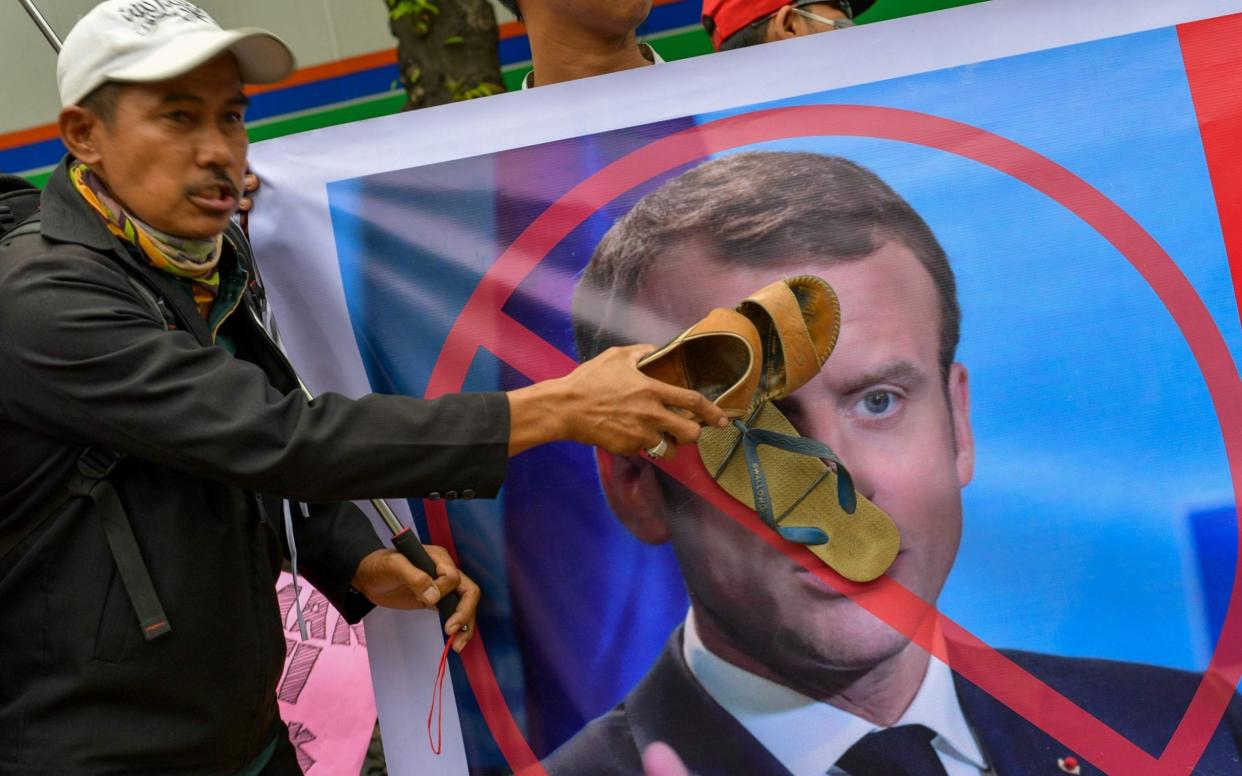 Muslim protesters display an image of French President Emmanuel Macron during an anti-France demonstration in Jakarta on November 4, 2020 -  BAY ISMOYO/AFP