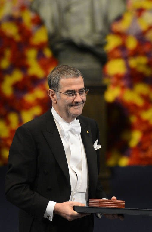 France's Serge Haroche, winner of the 2012 Nobel Prize in physics, reacts after he receives the award. The 2012 Nobel laureates in medicine, literature, economics, physics and chemistry received their prizes from Swedish King Carl XVI Gustaf at a gala ceremony in Stockholm on Monday