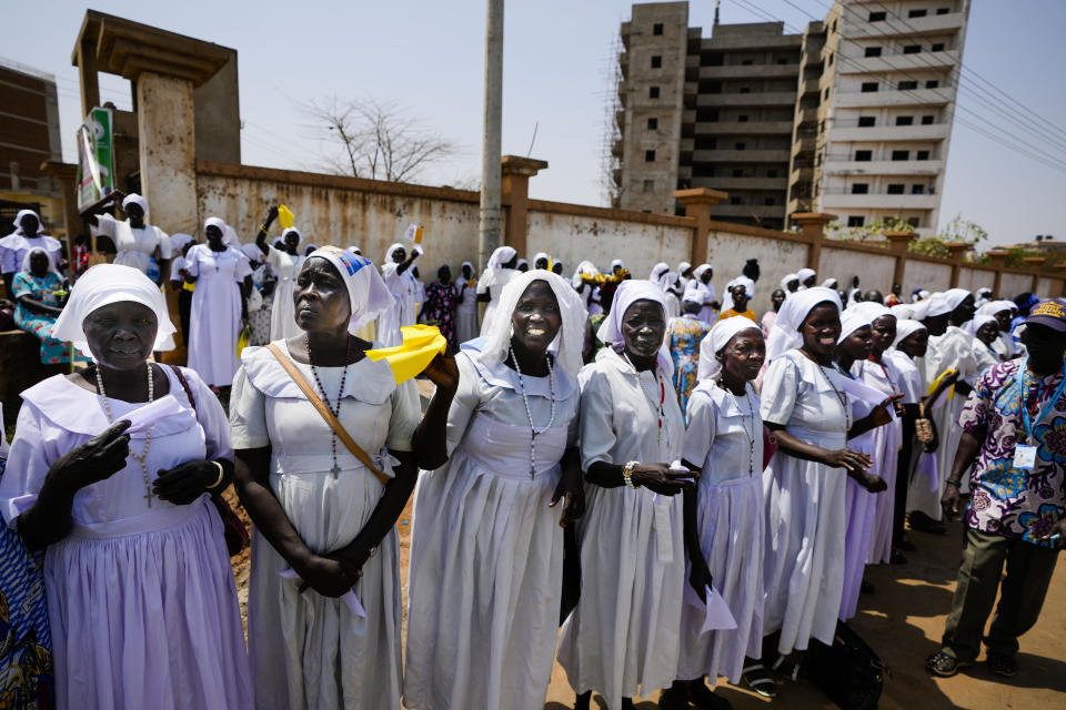 Faithful and nuns wait for the arrival of Pope Francis in Juba, South Sudan, Friday, Feb. 3, 2023. After meeting with members of the Congolese Bishops Conference in Kinshasa, Democratic Republic of Congo, Pope Francis is traveling to South Sudan on the second leg of a six-day trip that started in Congo, hoping to bring comfort and encouragement to two countries that have been riven by poverty, conflicts and what he calls a "colonialist mentality" that has exploited Africa for centuries. (AP Photo/Ben Curtis)