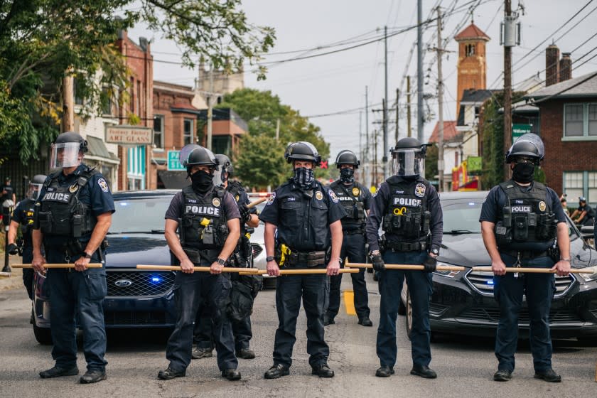 LOUISVILLE, KY - SEPTEMBER 23: Police officers form a line during protests on September 23, 2020 in Louisville, Kentucky. Protesters marched in the streets after a Kentucky Grand Jury indicted one of the three officers involved in the killing of Breonna Taylor with wanton endangerment. Taylor was fatally shot by Louisville Metro Police officers during a no-knock warrant at her apartment on March 13, 2020 in Louisville, Kentucky. (Photo by Brandon Bell/Getty Images)