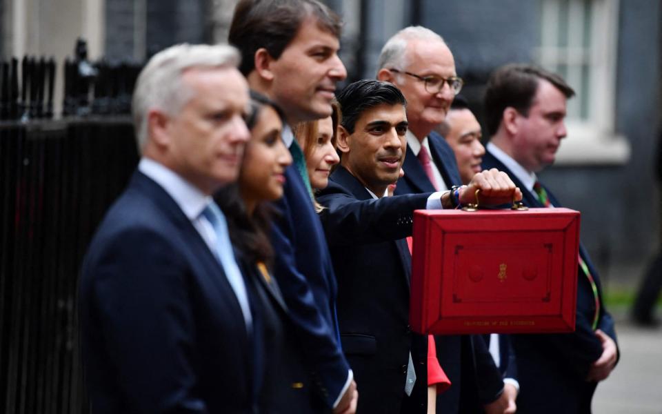 Rishi Sunak, the Treasury team and the red box containing his Budget - AFP