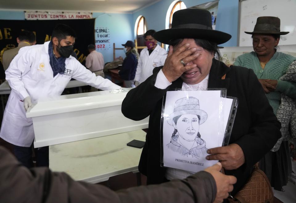 Rosa Ramirez cries after viewing the remains of her sister Primitiva Ramirez, who was killed during the Maoist-inspired insurgency, as authorities return the remains of victims to families in Accomarca, Peru, Wednesday, May 18, 2022. Peruvian authorities identified 80 remains as men, women and children who were killed between 1980 and 2000 by both members of the Shining Path militant group and army soldiers. (AP Photo/Martin Mejia)