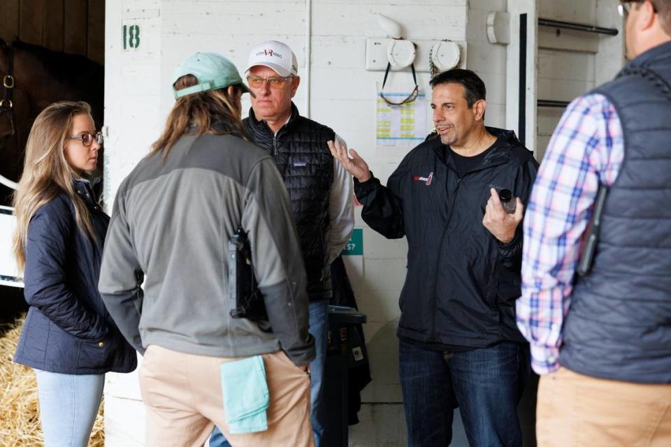 Mike Repole, owner of 2023 Kentucky Derby favorite Forte, right, discusses the availability of his horse for Saturday night’s race outside Forte’s barn at Churchill Downs in Louisville on Saturday morning with trainer Todd Pletcher and Dr. Nicholas Smith, the chief veterinarian of the Kentucky Horse Racing Commission (back to camera).