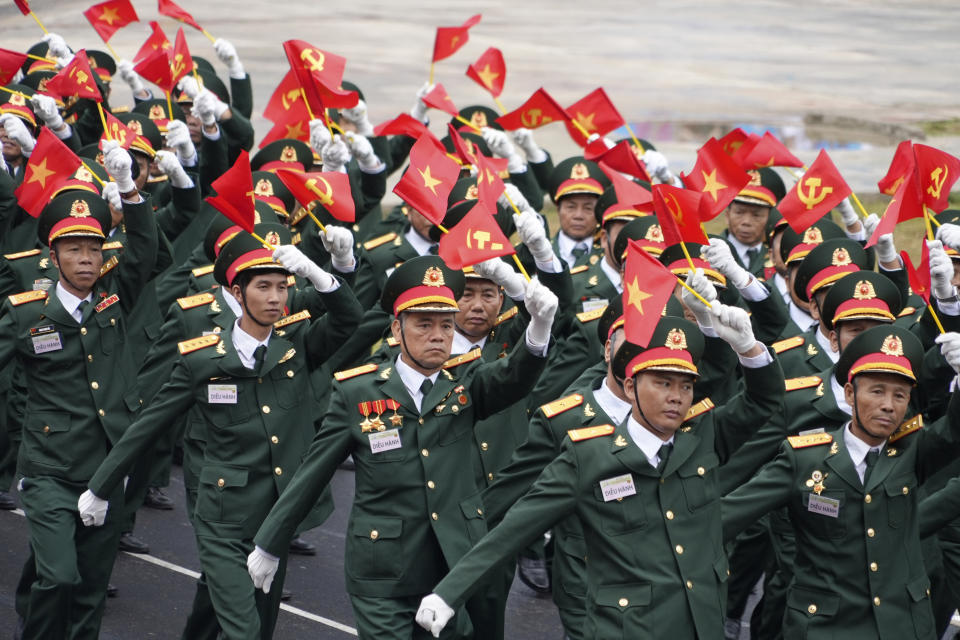 Participants march in a parade commemorating the victory of Dien Bien Phu battle in Dien Bien Phu, Vietnam, Tuesday, May 7, 2024. Vietnam is celebrating the 70th anniversary of the battle of Dien Bien Phu, where the French army was defeated by Vietnamese troops, ending the French colonial rule in Vietnam. (AP Photo/Hau Dinh)