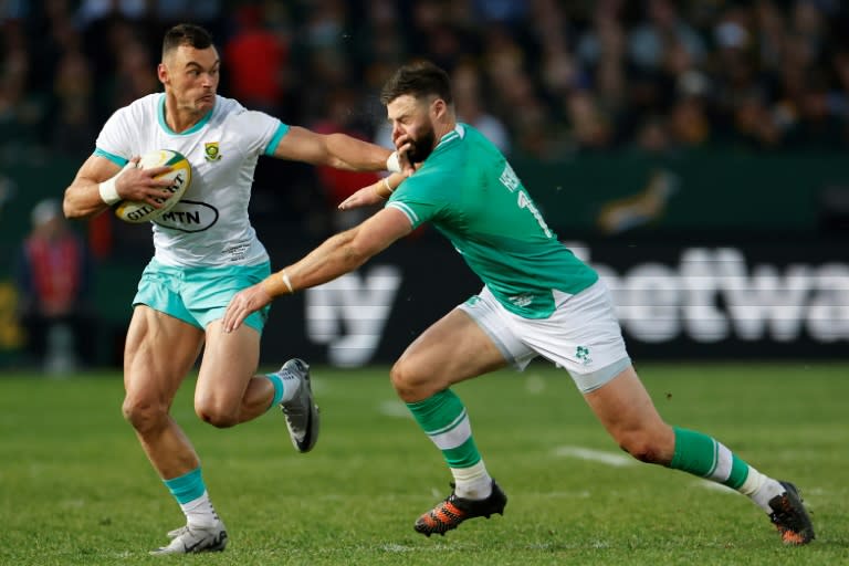 South African Jesse Kriel (L) hands off fellow centre Robbie Henshaw of <a class="link " href="https://sports.yahoo.com/soccer/teams/republic-of-ireland-women/" data-i13n="sec:content-canvas;subsec:anchor_text;elm:context_link" data-ylk="slk:Ireland;sec:content-canvas;subsec:anchor_text;elm:context_link;itc:0">Ireland</a> during the first Test in Pretoria. (PHILL MAGAKOE)