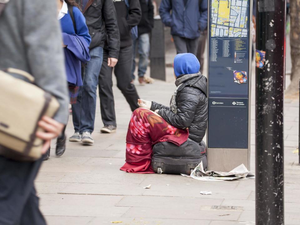 Two police officers posed with cardboard signs confiscated from beggars: Getty Images