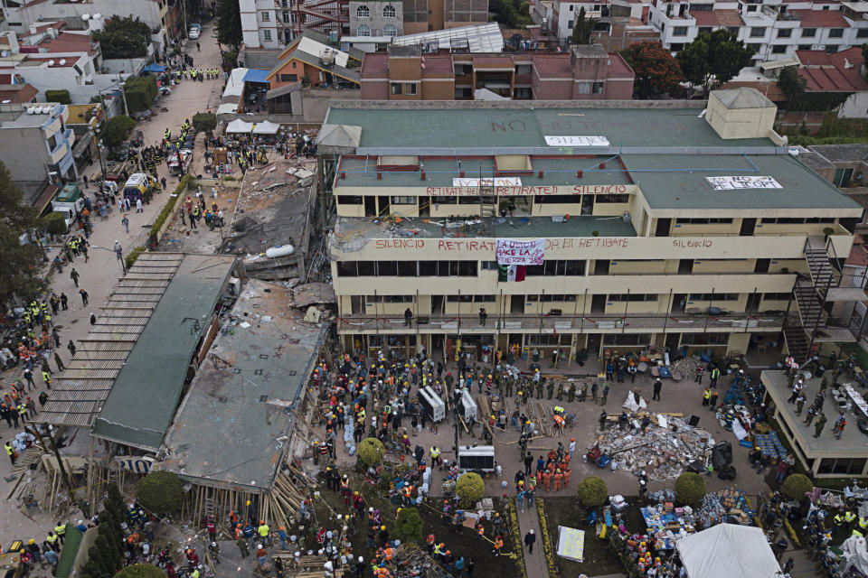 <p>Volunteers and rescue workers search for children trapped inside the Enrique Rebsamen school, collapsed by a 7.1 earthquake in southern Mexico City, Wednesday Sept. 20, 2017. (Photo: Miguel Tovar/AP) </p>