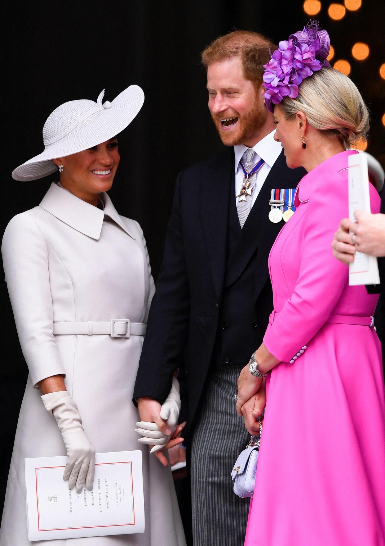 Britain's Prince Harry (C) and his wife Meghan, the Duke and Duchess of Sussex, speak to Zara Tindall (R) at the end of the National Service of Thanksgiving for The Queen's reign at Saint Paul's Cathedral in London on June 3, 2022 as part of Queen Elizabeth II's platinum jubilee celebrations. - Queen Elizabeth II kicked off the first of four days of celebrations marking her record-breaking 70 years on the throne, to cheering crowds of tens of thousands of people. But the 96-year-old sovereign's appearance at the Platinum Jubilee -- a milestone never previously reached by a British monarch -- took its toll, forcing her to pull out of a planned church service. (Photo by TOBY MELVILLE / POOL / AFP) (Photo by TOBY MELVILLE/POOL/AFP via Getty Images)