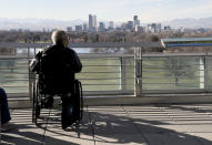 Walter Hill, of Westminster, Colo., enjoys the warm weather and the view of downtown Denver on Friday, Dec. 3, 2021. The Mile High City has already shattered its 87-year-old record for the latest measurable snowfall set on Nov. 21, 1934, and it's a little more than a week away from breaking an 1887 record of 235 consecutive days without snow. (AP Photo/Thomas Peipert)