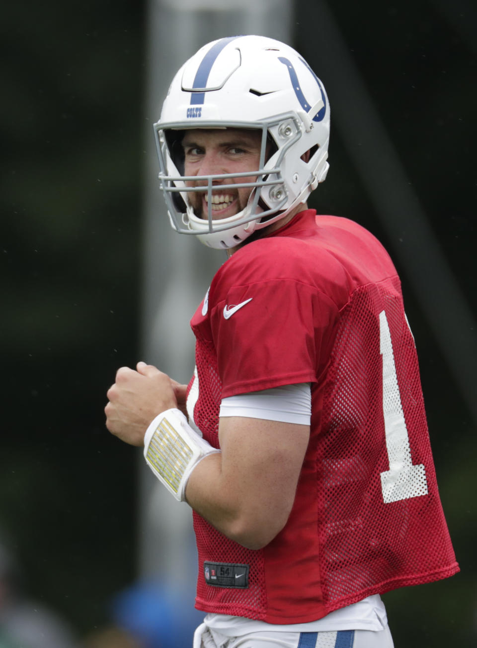 Indianapolis Colts quarterback Andrew Luck (12) smiles as he throws during practice at the NFL team's football training camp in Westfield, Ind., Sunday, July 29, 2018. (AP Photo/Michael Conroy)