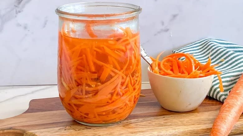Cut carrots in liquid in glass jar 