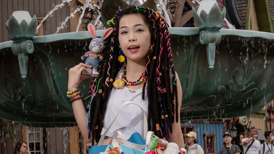 Ankh Wong poses for a picture in front of the snowflake fountain popular with influencers in the World of Frozen, Hong Kong Disneyland's latest attraction. - Noemi Cassanelli/CNN