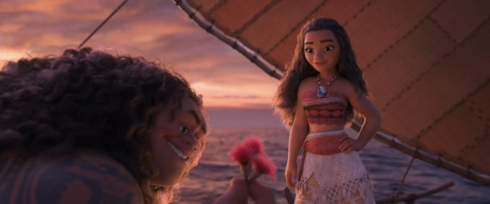 Animated characters Maui and Moana on a boat, Maui smiling at Moana who is holding an oar