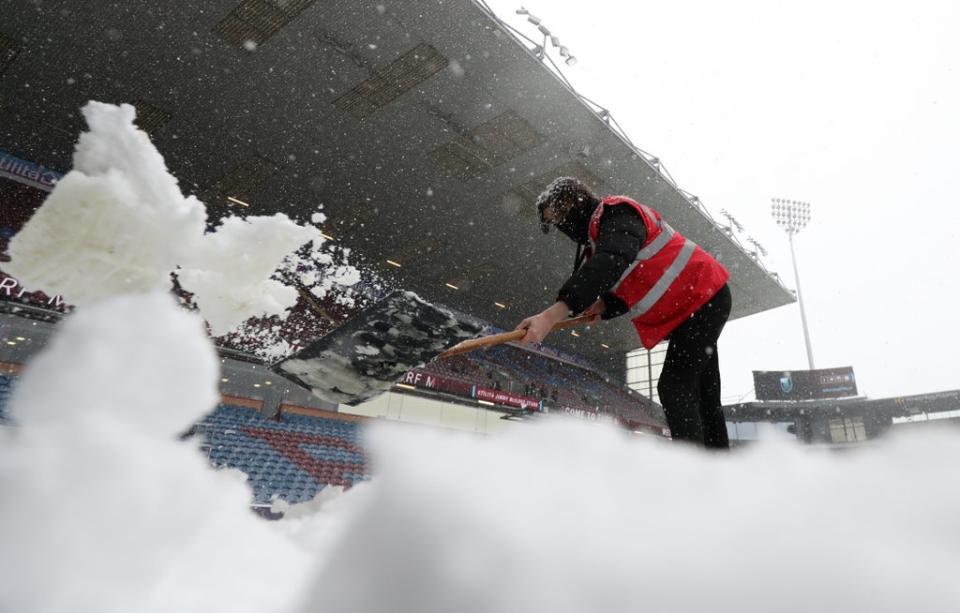 Efforts to clear the Turf Moor pitch were in vain as Burnley’s match against Tottenham was postponed (Bradley Collyer/PA) (PA Wire)