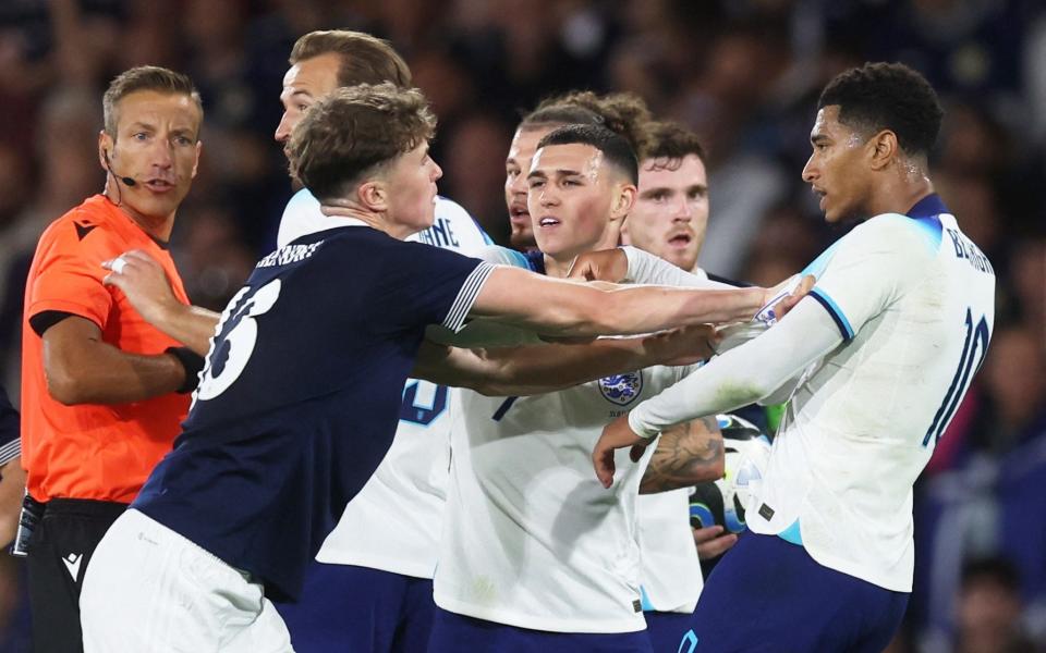 Scotland's Jack Hendry clashes with England's Jude Bellingham