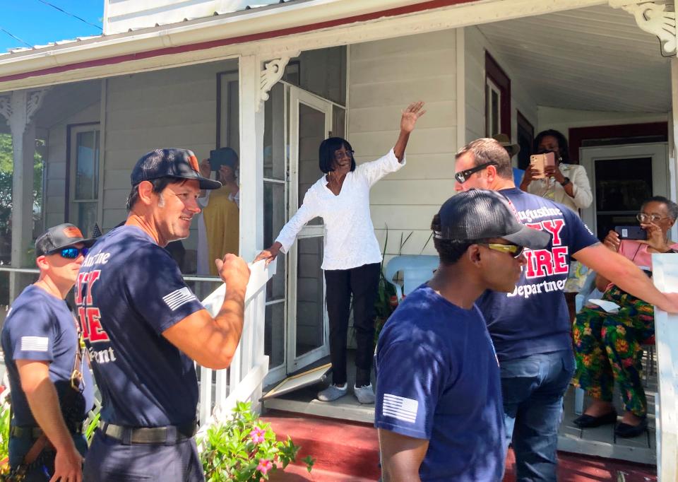 Cora Tyson waves to a procession held in her honor on Wednesday, her 99th birthday, in front of her home in Lincolnville. Firefighters, law enforcement, family, friends and members of her church attended. Tyson provided shelter to Martin Luther King Jr. during the civil rights movement in St. Augustine.