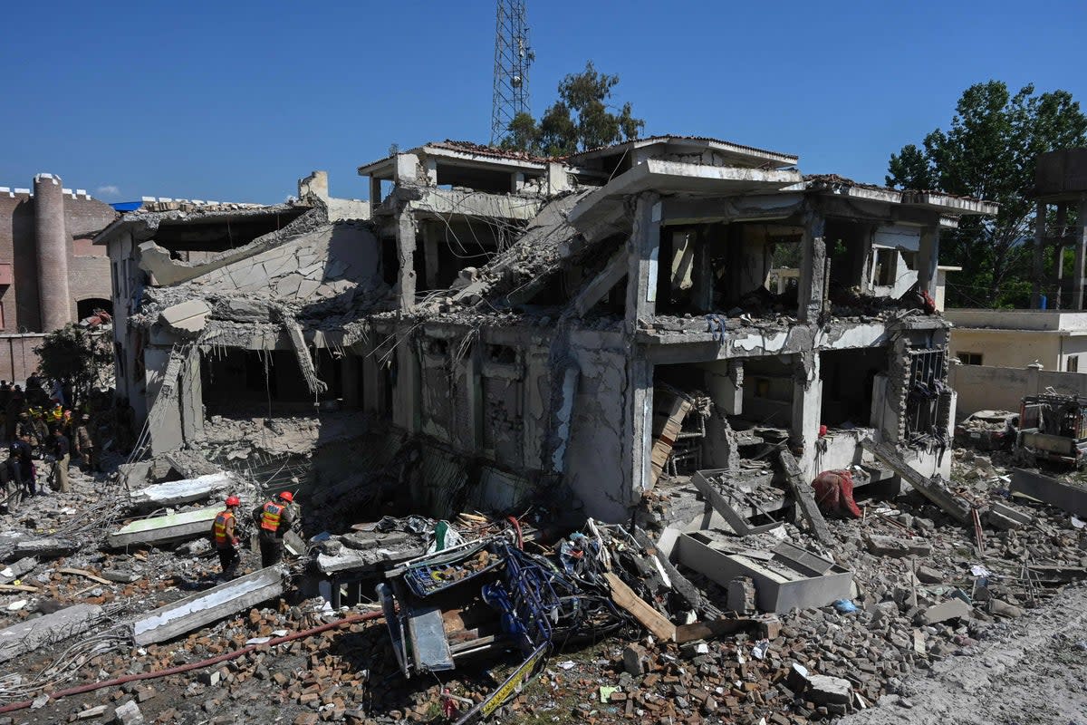 Rescue teams search for victims in the rubble of a badly damaged building a day after multiple explosions caused by fire in a munitions cache levelled a specialist counter-terrorism police station in Kabal  (AFP via Getty Images)