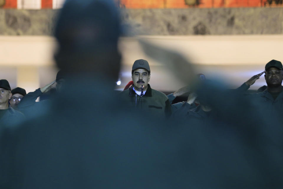 In this handout photo released by Miraflores Press Office, Venezuela's President Nicolas Maduro, center, attends a meeting with troops at Fort Tiuna in Caracas, Venezuela, Thursday, May 2, 2019. Flanked by commanders, Maduro said Thursday that the military must be prepared to combat "traitors", two days after opposition leader Juan Guaidó called for the military to turn against Maduro. (Jhonn Zerpa/Miraflores Press Office via AP)