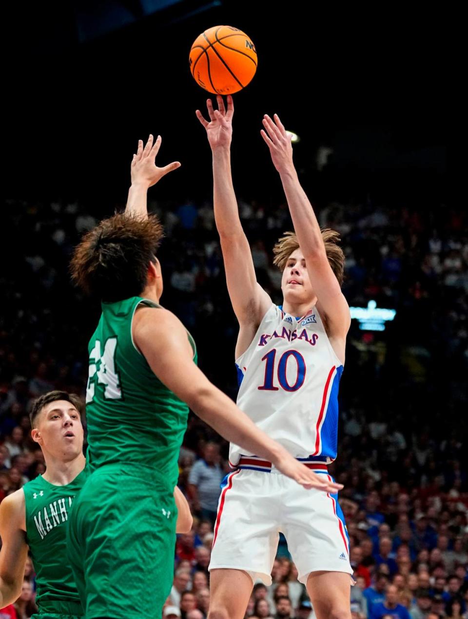 Kansas Jayhawks guard Johnny Furphy shoots against Manhattan’s Xinyi Li (No. 24) and Brett Rumpel (No. 4) during Friday night’s game at Allen Fieldhouse.