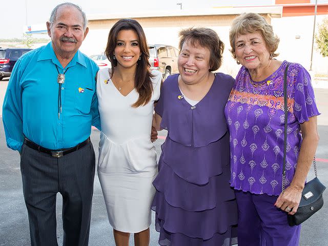 <p>Rick Kern/Getty</p> Eva Longoria with her dad Enrique Longoria, sister Elizabeth Judina Longoria and mom Ella Eva Mireles in 2014.