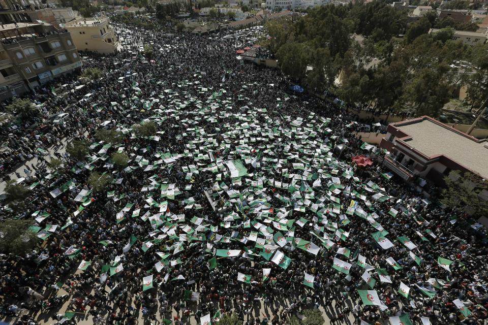 Demonstrators hold Algerian flags during a protest in Bordj Bou Arreridj, east of Algiers, Friday, April 26, 2019. Algerians are massing for a 10th week of protests against their country's ruling class, calling for the ex-president's brother to be put on trial. (AP Photo/Toufik Doudou)