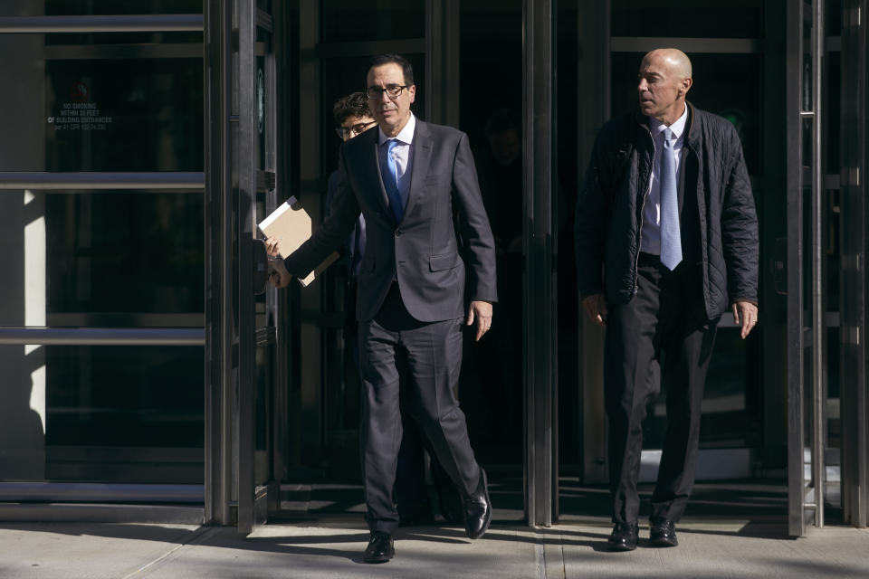 Former United States Secretary of the Treasury, Steven Mnuchin, center, leaves the Brooklyn Federal Court on Thursday, Oct. 20, 2022, in the Brooklyn borough of New York. (AP Photo/Andres Kudacki)