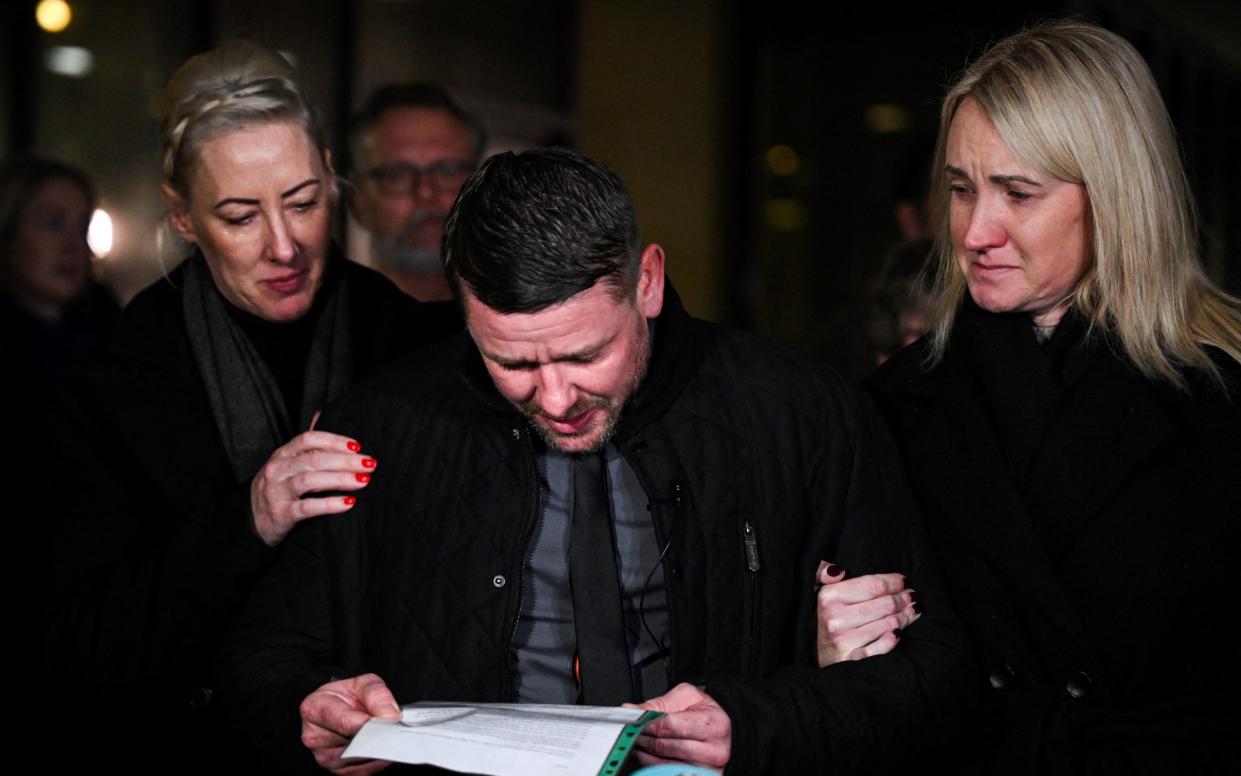 Peter Spooner, Brianna's father, is held up by supporters as he reads a message to the media outside the courtroom