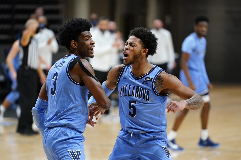 Villanova's Brandon Slater, left, and Justin Moore react after a basket during the first half of an NCAA college basketball game against St. John's, Tuesday, Feb. 23, 2021, in Villanova, Pa. (AP Photo/Matt Slocum)