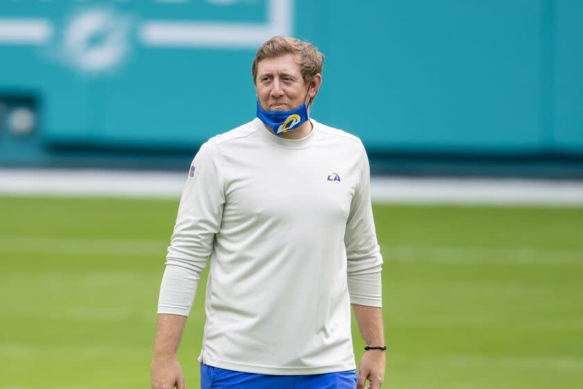 Los Angeles Rams assistant quarterbacks coach Liam Coen smiles on the field before the Rams.