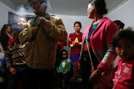 Refugees who fled fighting in neighbouring Myanmar gather in the house of a relative in the village of Baiyan near Nansan in the Yunnan province, China, March 11, 2017. REUTERS/Thomas Peter