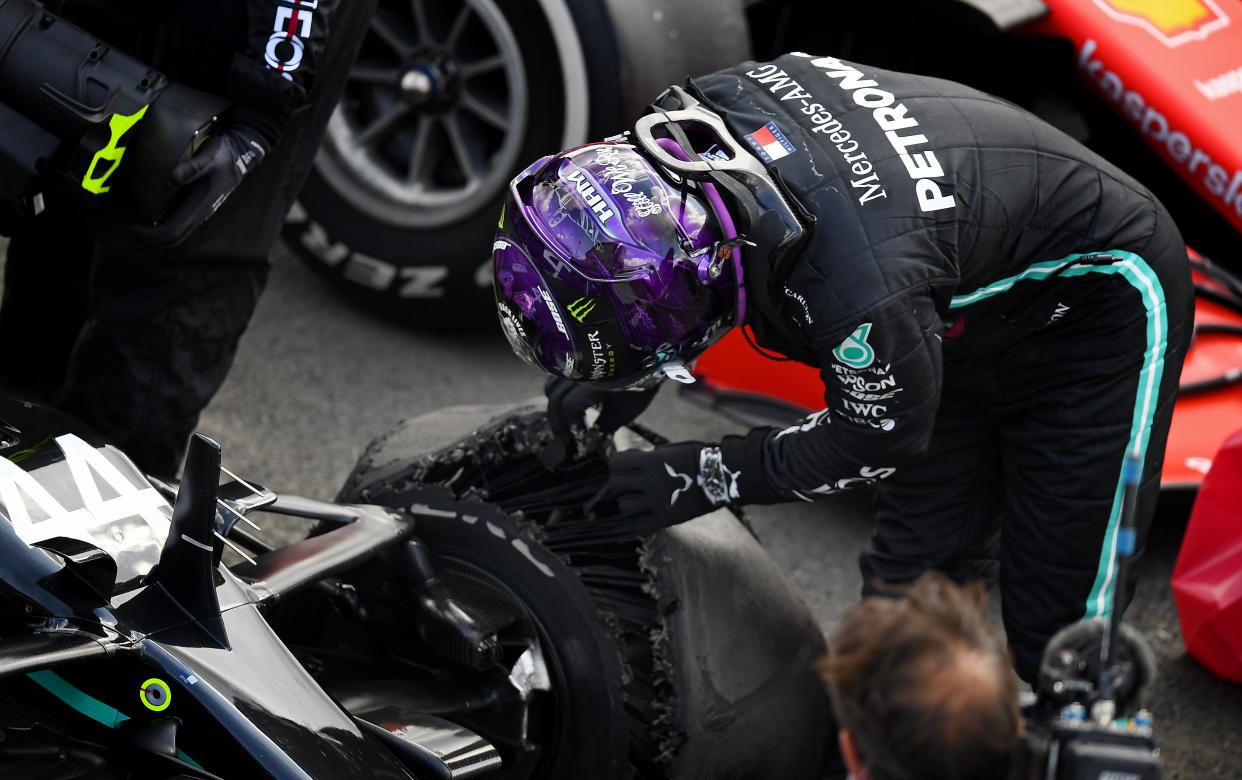 NORTHAMPTON, ENGLAND - AUGUST 02: Race winner Lewis Hamilton of Great Britain and Mercedes GP inspects his tyre in parc ferme after getting a puncture on the last lap during the F1 Grand Prix of Great Britain at Silverstone on August 02, 2020 in Northampton, England. (Photo by Clive Mason - Formula 1/Formula 1 via Getty Images)