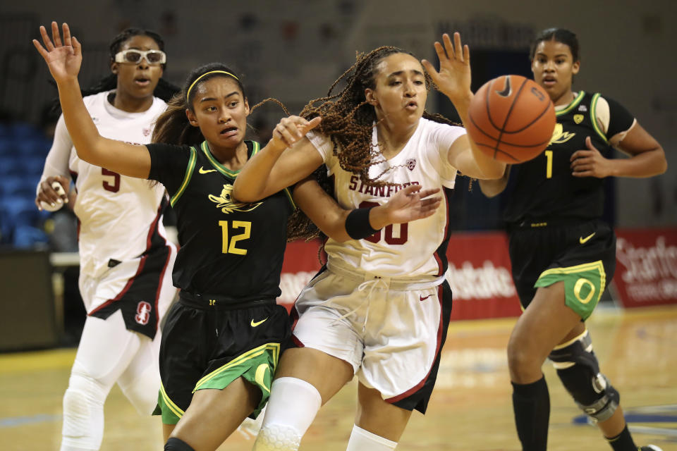 Stanford guard Haley Jones and Oregon guard Te-Hina Paopao battle for a rebound during the first half of an NCAA college basketball game in Santa Cruz, Calif., Friday, Jan. 8, 2021. (AP Photo/Jed Jacobsohn)