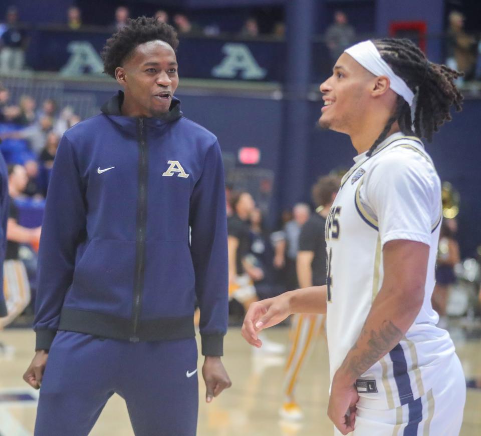 Akron Zips guard Ali Ali, left, talks with teammate Nate Johnson before the game against Southern Miss, Friday, Nov. 10, 2023.