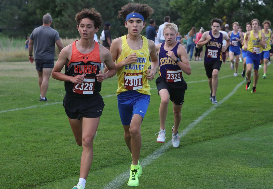 Huron's Cheech Harmon leads Aberdeen Central's Christian Wells during the Salmi/Sahli Invitational cross-country meet Thursday at Lee Park. Wells finished third, Harmon fourth.