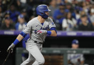 Los Angeles Dodgers' Gavin Lux follows the flight of his RBI-double off Colorado Rockies starting pitcher German Marquez in the fourth inning of a baseball game Wednesday, Sept. 22, 2021, in Denver. (AP Photo/David Zalubowski)