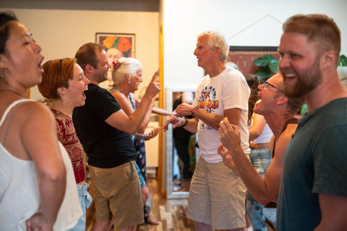 Laughter yoga students participate in a laughing role play performance at Cafe Gratitude. Laughter yoga requires no yoga mat and is accessible to all ages and body types. Zachary Linhares/zlinhares@kcstar.com