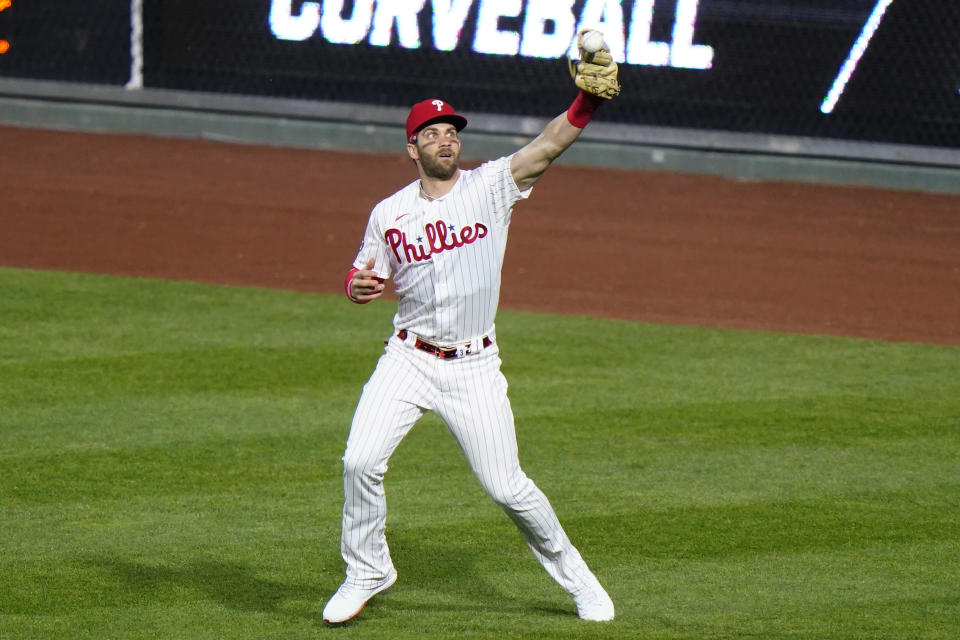 Philadelphia Phillies right fielder Bryce Harper fields a run-scoring single by New York Mets' Michael Conforto during the third inning of baseball game, Sunday, May 2, 2021, in Philadelphia. (AP Photo/Matt Slocum)